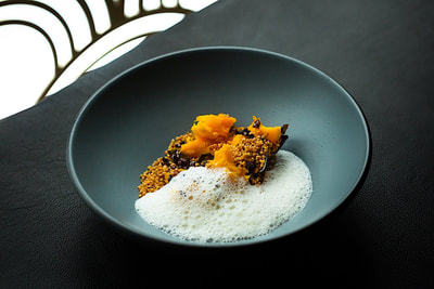 an elegant dish served in a black bowl at Gibson
