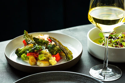 An elegant and upscale meal with a glass of white wine