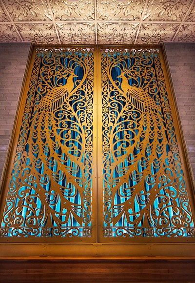 an art-deco style window fixture depicting two peacocks 
